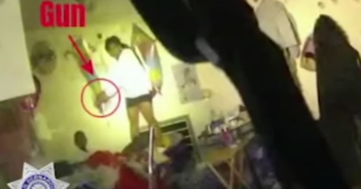 Officers kicked open the door and say they saw Darvet Brown standing on a bed pointing a gun at the child  (San Bernardino Police)