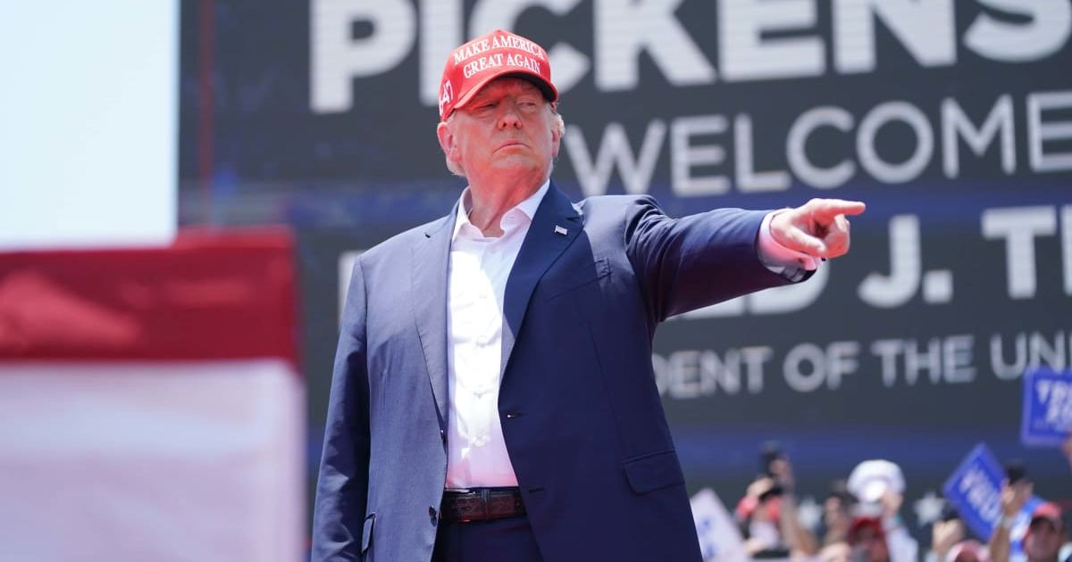 Donald Trump was heckled by climate protestors at a pre-caucus rally in Iowa (Sean Rayford/Getty Images)