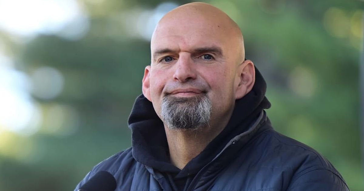 Pennsylvania Senator John Fetterman has shown support for Israel by unfurling a large Israeli flag from his rooftop as pro-Palestinian protestors demonstrated outside his home (Getty Images)