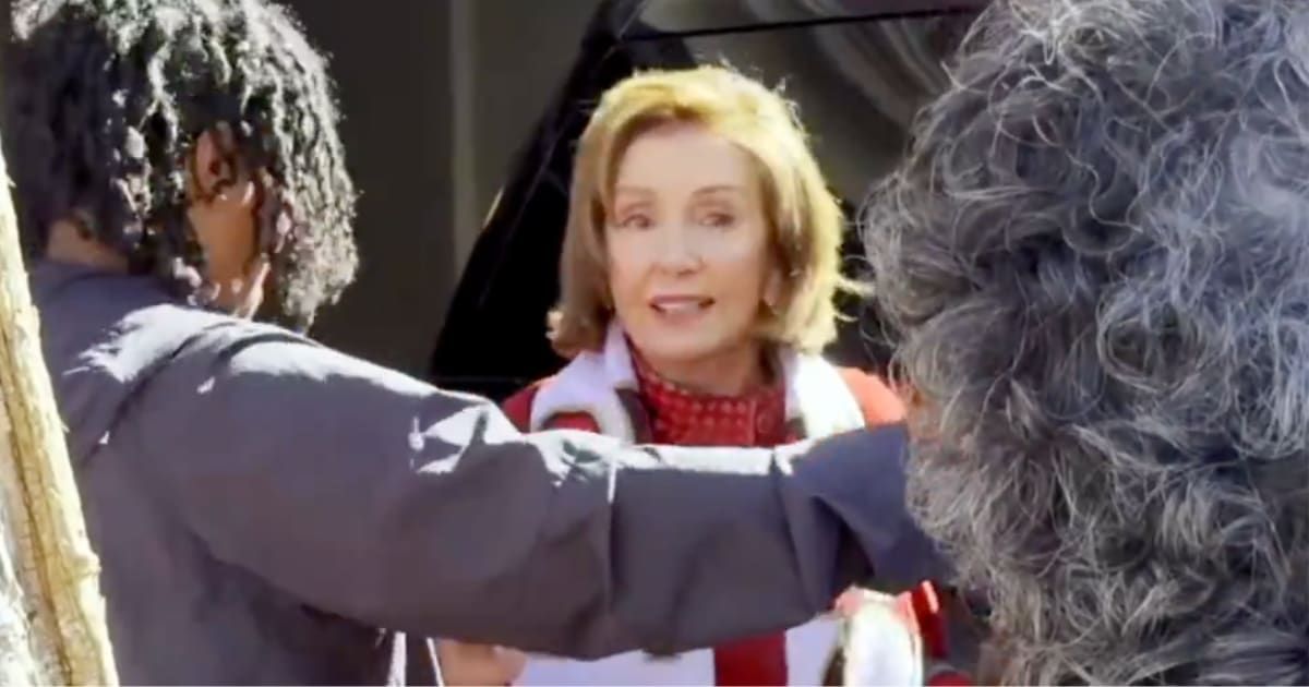 A clip, filmed in October 2023, captures a tense exchange between Nancy Pelosi and demonstrators as she attempts to get into her vehicle (HalalFlow/X)