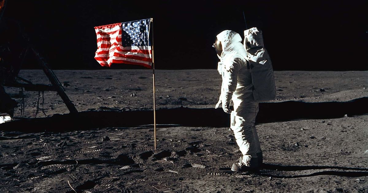 Astronaut Edwin E Aldrin, Jr, the lunar module pilot of the first lunar landing mission, stands next to a United States flag July 20, 1969 during an Apollo 11 Extravehicular Activity (EVA) on the surface of the Moon (NASA/Newsmakers)
