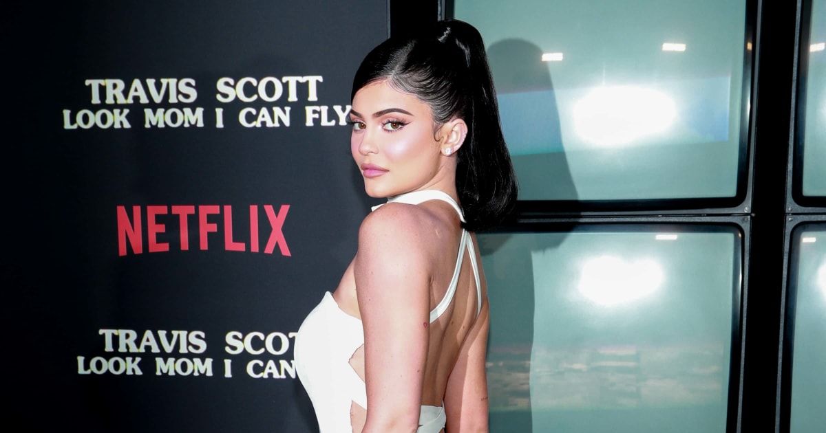 Kylie Jenner wore multiple silver earrings besides the rings and even brought a few knitted bags and some black flip-flops with her to the beach (Getty Images)