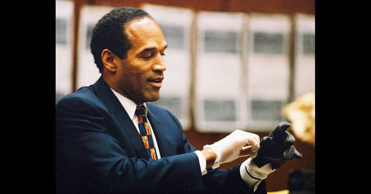 OJ Simpson tries on a black leather glove allegedly used in the murders of Nicole Brown Simpson and Ronald Goldman (Lee Celano/WireImage)