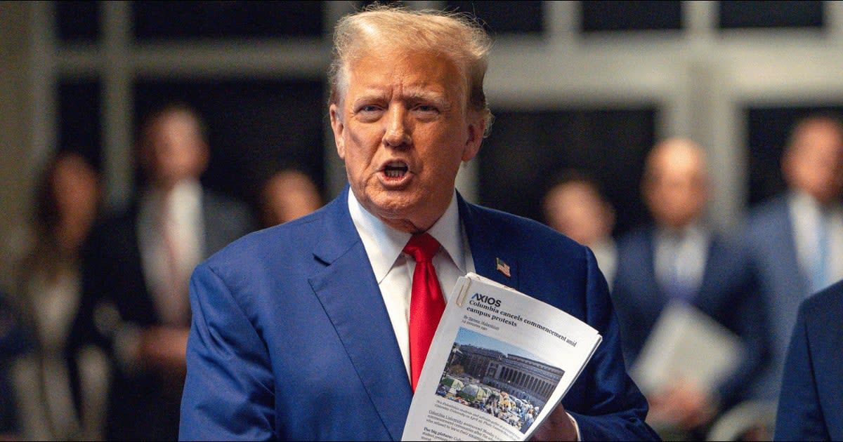 Donald Trump held a stack of articles about Columbia University's graduation cancellation as he criticized the university's decision (Getty Images)