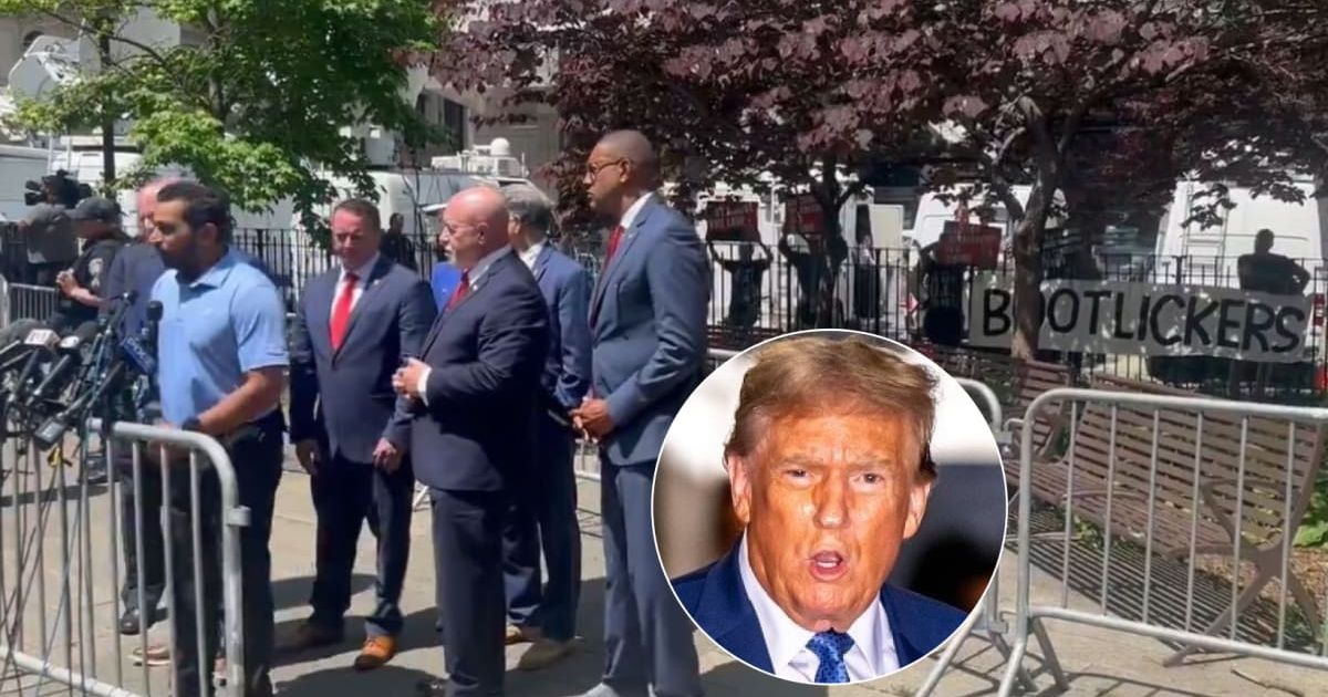 Donald Trump's supporters were dressed in Trump's navy suit and red tie when a protester showed a 'bootlicker' sign to drown them out (@JSweetLI/ X, Getty Images)