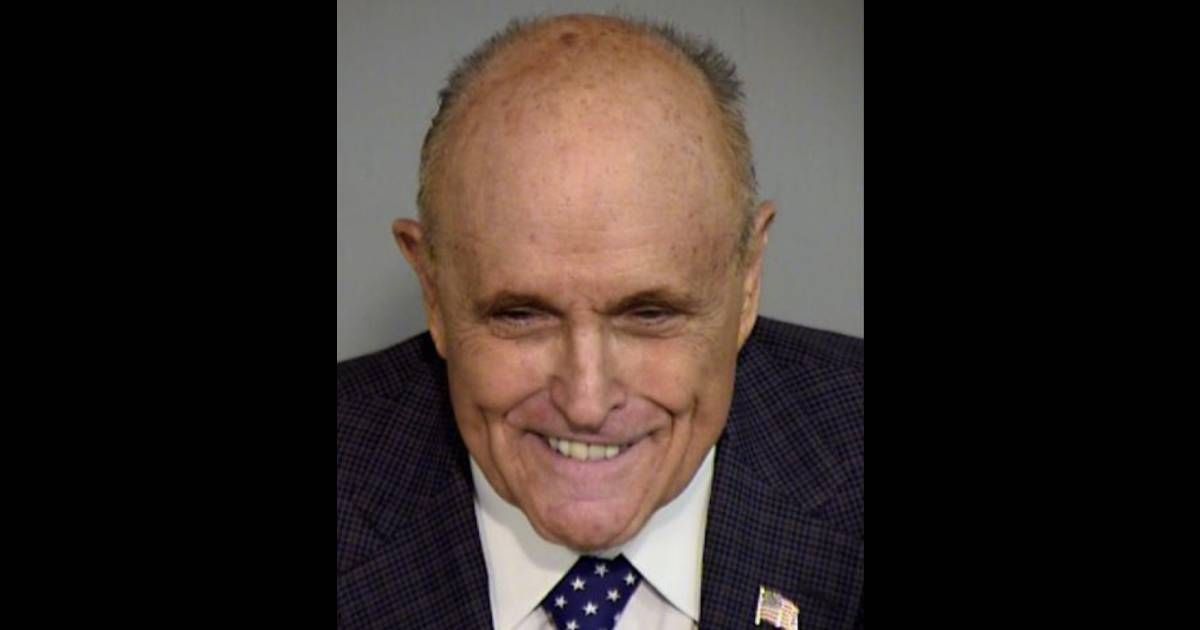 Rudy Giuliani is seen grinning in his mugshot after being indicted in Arizona (Maricopa County Sheriff's Office)