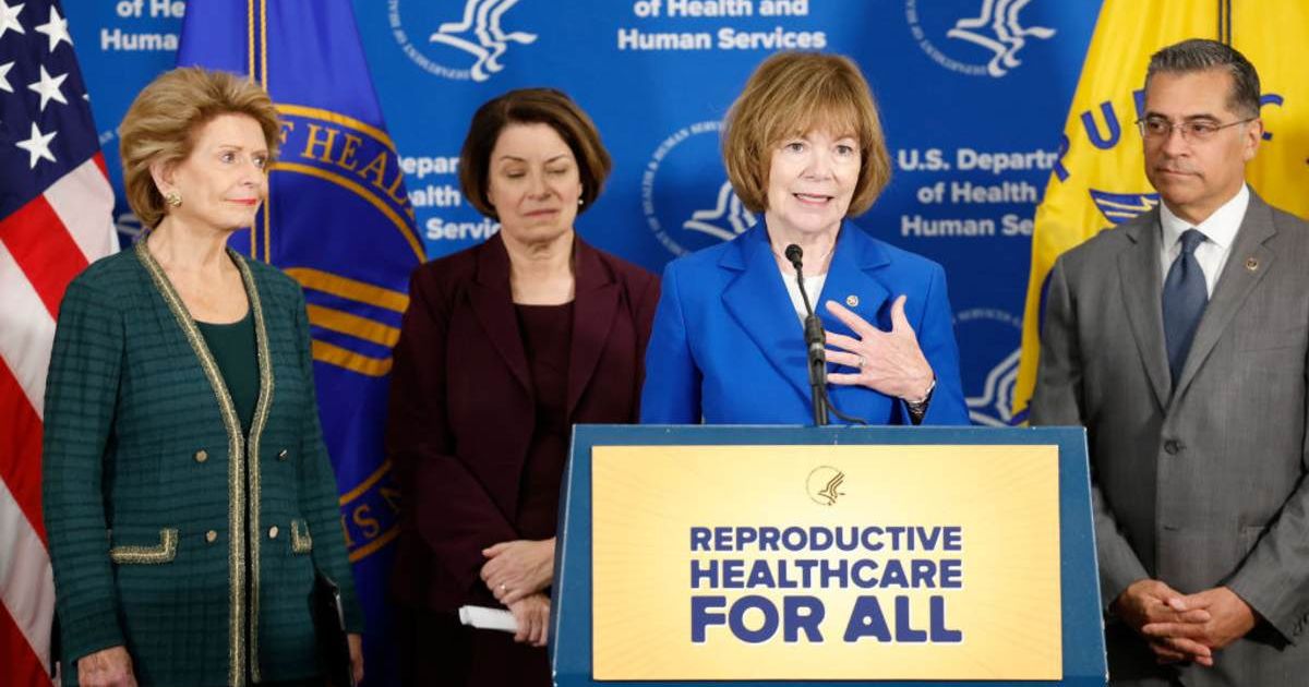 Senator Tina Smith alongside Health and Human Services Secretary Xavier Becerra and Senate Democrats (Getty Images)