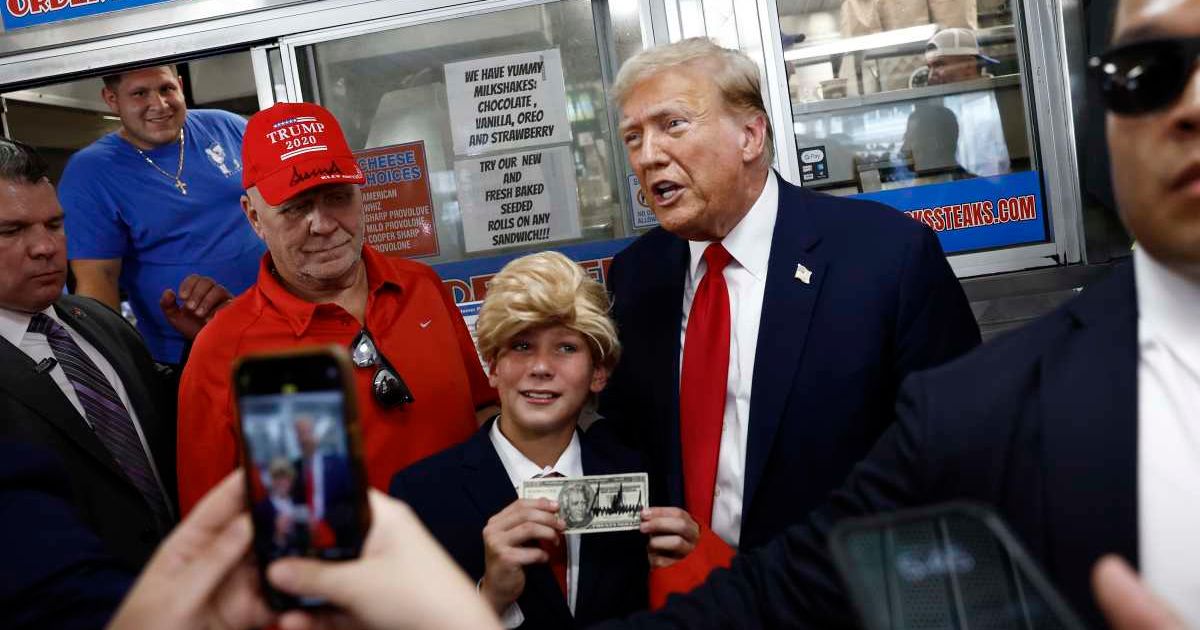 Former President Donald Trump poses for a photo with a child dressed as him at sandwich stop Tony and Nick's Steaks on June 22, 2024, in Philadelphia (Getty Images)