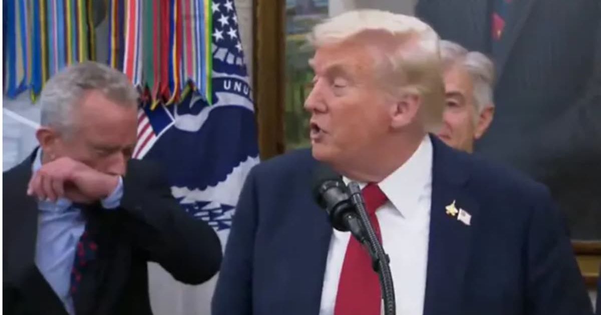 As Donald Trump outlined TrumpRx with Pfizer CEO Albert Bourla, Robert F Kennedy Jr, standing a foot away, sneezed into his elbow (Screenshot/X)