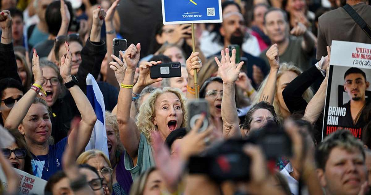 People react as they watch the hostage release live stream at Hostages Square on October 13, 2025, in Tel Aviv, Israel (Alexi J Rosenfeld/Getty Images)