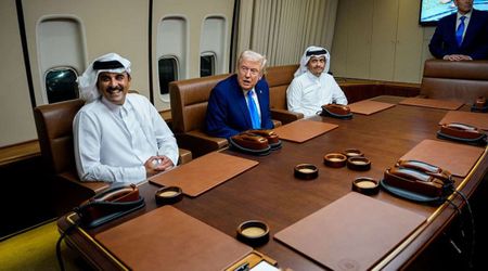 Trump greets Qatari emir aboard Air Force One during refueling stop en route to Asia