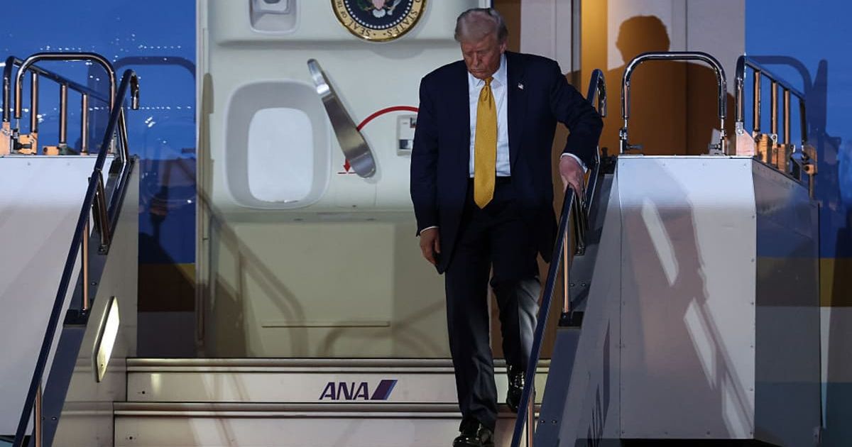 President Donald Trump descended the steps of Air Force One slowly and carefully, keeping his eyes on the ground while tightly gripping the handrail (Takashi Aoyama/Getty Images)