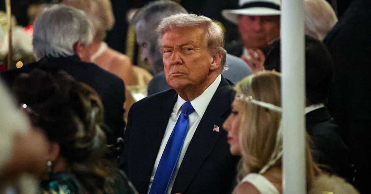 Donald Trump talks with guests during a Halloween party at his Mar-a-Lago estate on October 31, 2025, at Palm Beach, Florida (Samuel Corum/Getty Images)