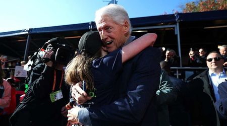 Bill Clinton wears mysterious nose bandage while cheering daughter Chelsea at NYC marathon