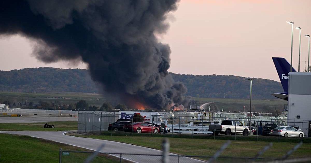 Fire and smoke mark where a UPS cargo plane crashed near Louisville Muhammad Ali International Airport on November 4 in Louisville, Kentucky ( Stephen Cohen/Getty Images)