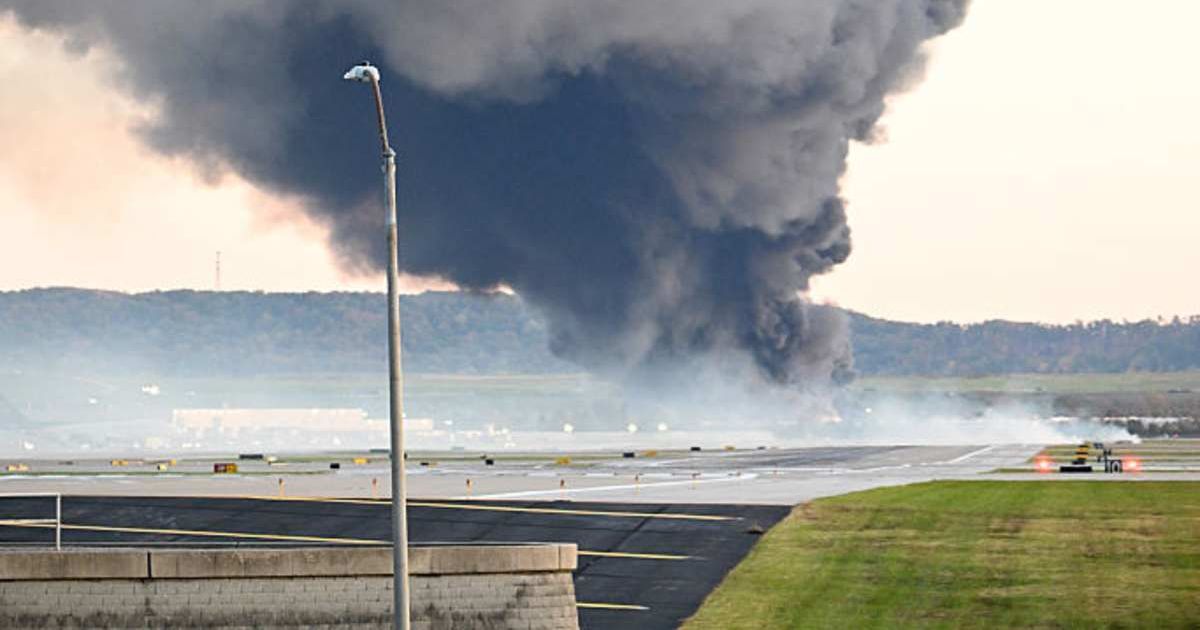 Fire and smoke rose where a UPS cargo plane crashed near Louisville Muhammad Ali International Airport on November 4, 2025 (Stephen Cohen/Getty Images)