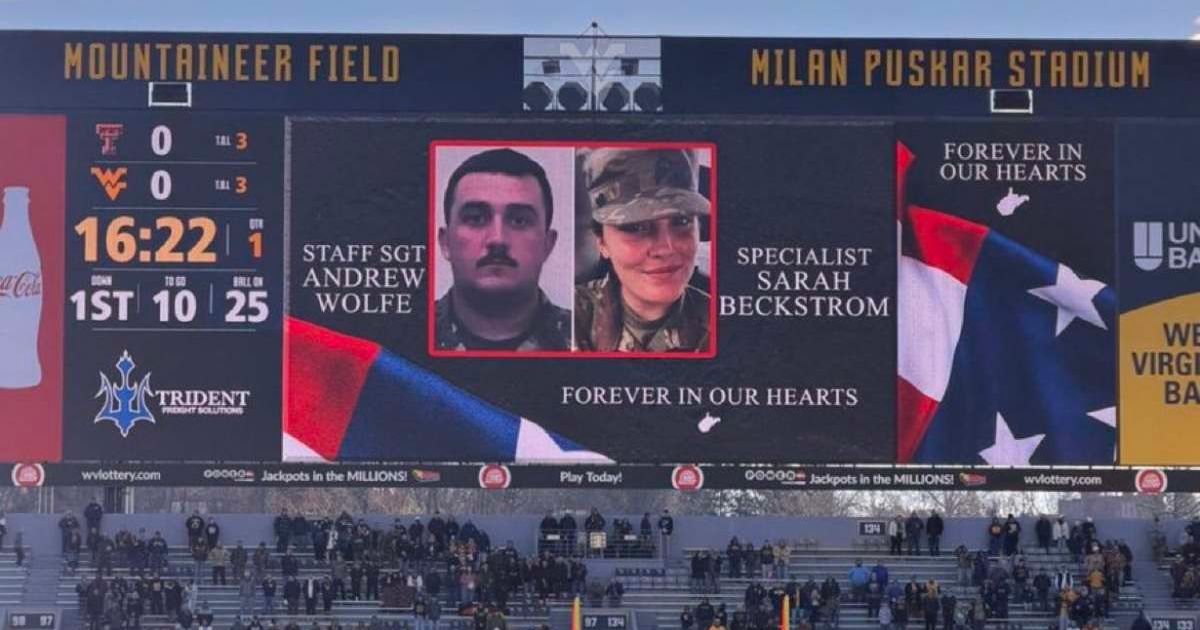 The crowd at the football game observed a moment of silence for the two National Guard soldiers, Andrew Wolfe and Sarah Beckstrom, who were shot in the DC attack (@ElectionWiz/X)