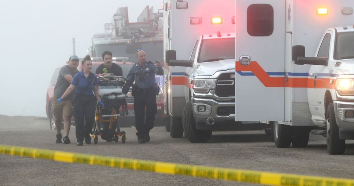 Emergency personnel rush a victim of a small plane crash to an awaiting ambulance, Monday, Dec 22, 2025, near the causeway, in Galveston, Texas (Jennifer Reynolds/The Galveston County Daily News via AP) 