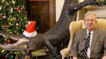 John Kennedy sends Christmas greetings with taxidermied alligator at his side