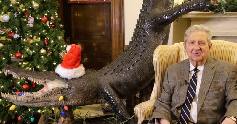 John Kennedy sends Christmas greetings with taxidermied alligator at his side