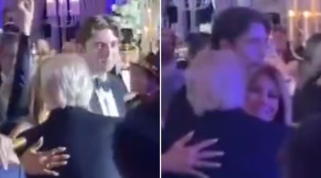 Melania hugs, kisses President Trump at New Year’s Eve party as Barron looks on smiling