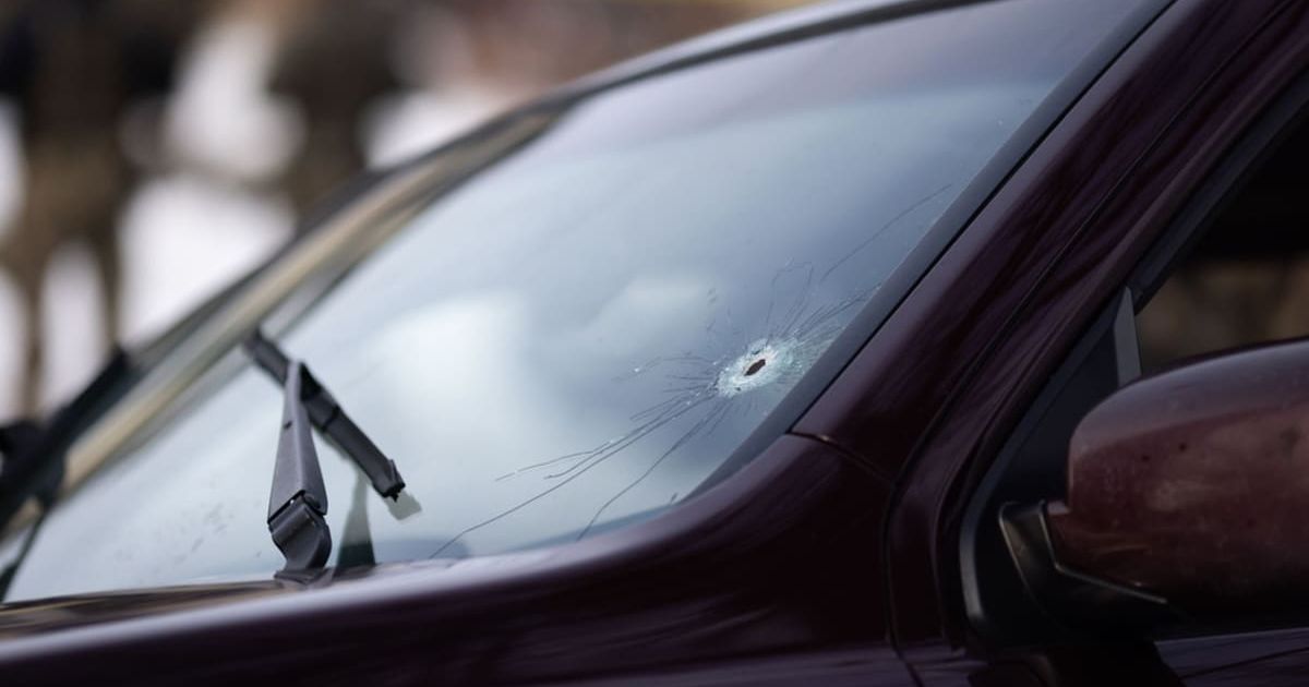 A bullet hole is seen on the windshield of a vehicle at the scene of a shooting in Minneapolis on Wednesday, Jan 7, 2026 (Ben Hovland /Minnesota Public Radio via AP)