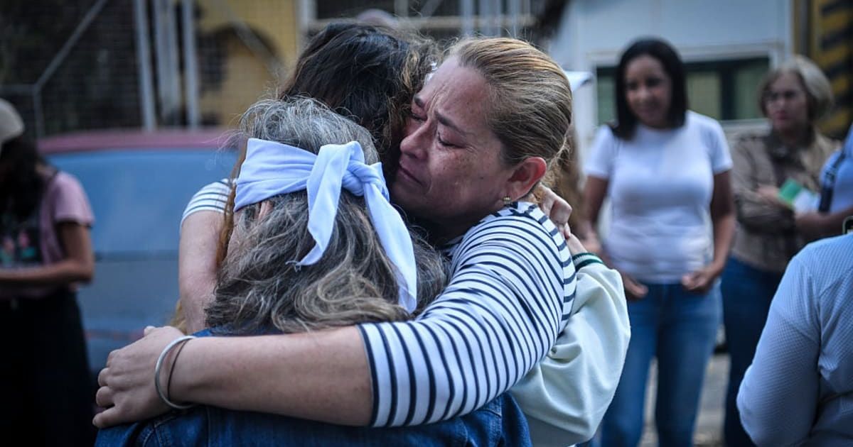 Relatives of detainees embrace after praying outside a detention center in Boleita as they await the release of political prisoners on January 12, 2026, in Caracas, Venezuela (Carlos Becerra/Getty Images)