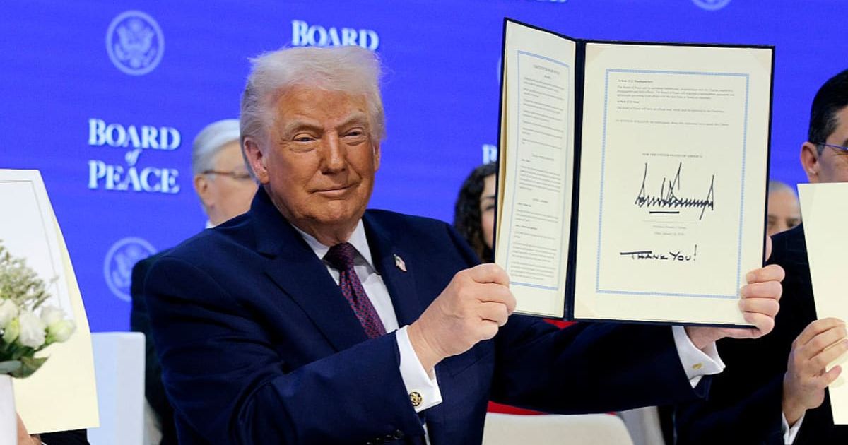President Donald Trump holds up his signature on the founding charter during a signing ceremony for the “Board of Peace” at the World Economic Forum (WEF) on January 22, 2026 in Davos, Switzerland (Getty Images)