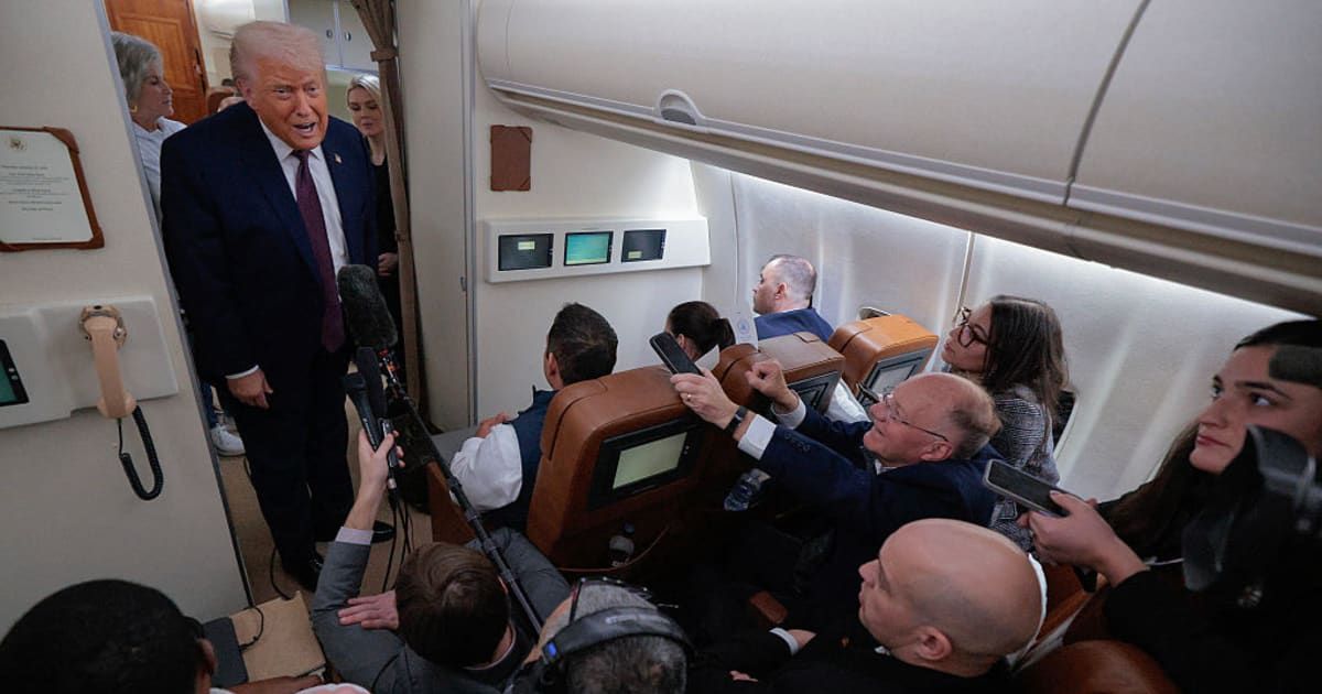 US President Donald Trump speaks to reporters on board Air Force One while flying in between Ireland and Washington as he returns from the World Economic Forum on January 22 at Joint Base Andrews, Maryland (Chip Somodevilla/Getty Images)