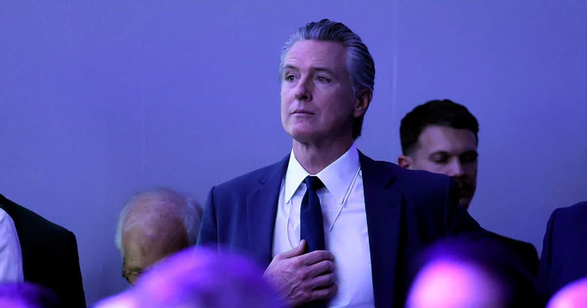 Gavin Newsom, the governor of California, watches as Donald Trump gives a speech at the World Economic Forum (WEF) on January 21, 2026, in Davos, Switzerland (Chip Somodevilla/Getty Images)