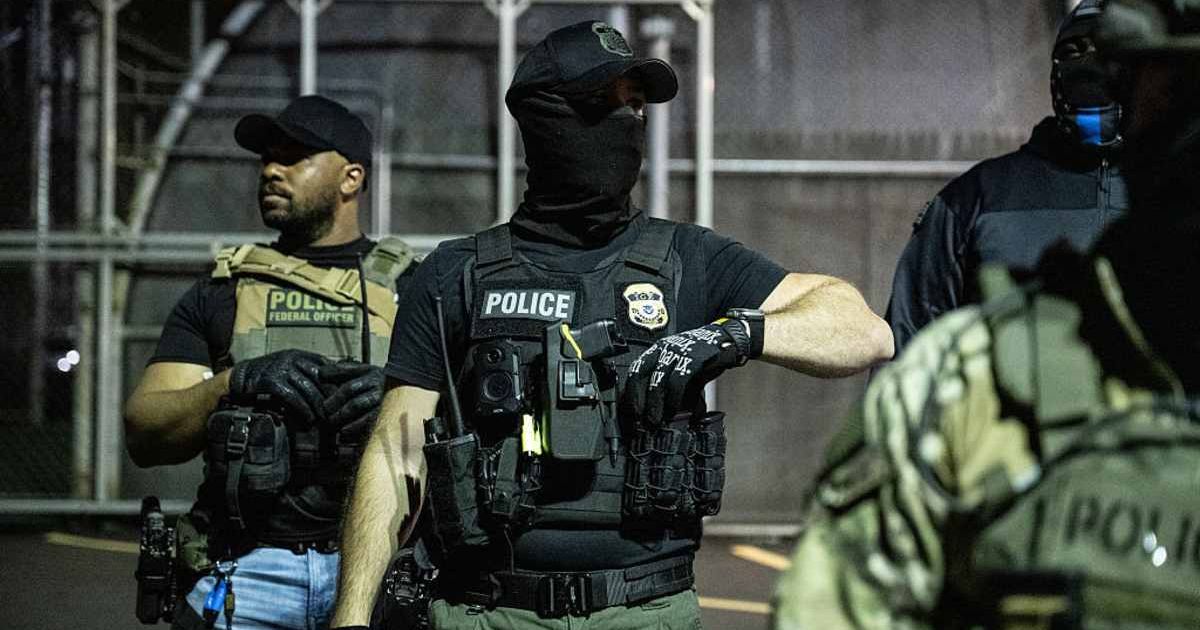 Immigration and Customs Enforcement (ICE) agents guard outside Delaney Hall, a migrant detention facility, while anti-ICE activists demonstrate on June 12, 2025, in Newark, New Jersey (Getty Images)