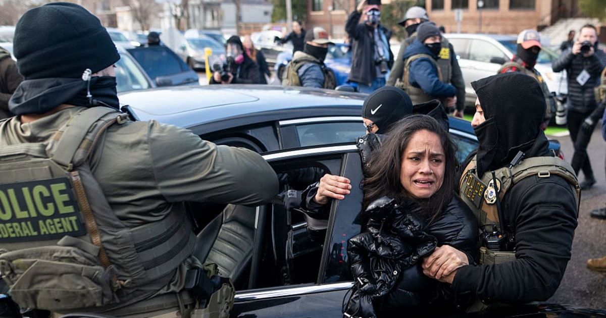 ICE agents detain a woman after pulling her from a car on January 13, 2026, in Minneapolis, Minnesota (Stephen Maturen/Getty Images)