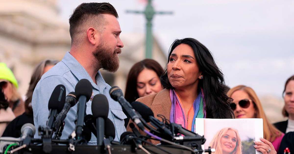 Sky Roberts, brother of Virginia Giuffre and his wife Amanda Roberts hold up a photo of Giuffre as they speak during a news conference on the Epstein Files Transparency Act on November 18, 2025 in Washington, DC (Getty Images)