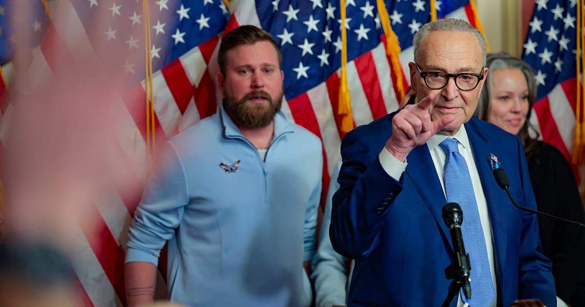 Senate Minority Leader Chuck Schumer, joined by relatives of Epstein survivors, introduced ‘Virginia’s Law’ on Tuesday (Getty Images)