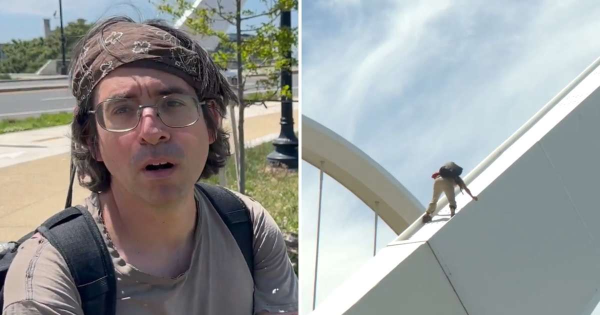 Footage from the scene showed the protester atop the structure, appearing to broadcast or speak live while positioned above the roadway (Screengrab/X/@FordFischer)