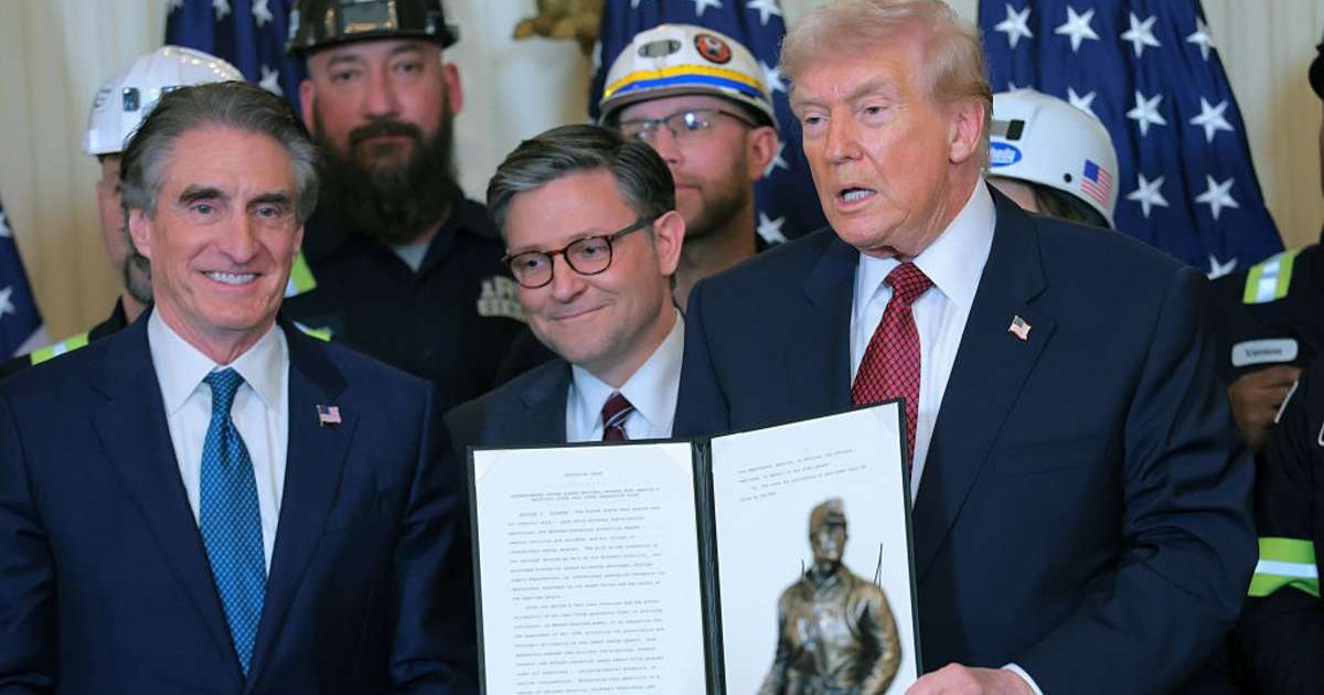 Donald Trump held up an executive order alongside coal workers and Interior Secretary Doug Burgum and Speaker Mike Johnson during a White House event on coal use (Anna Moneymaker/Getty Images)