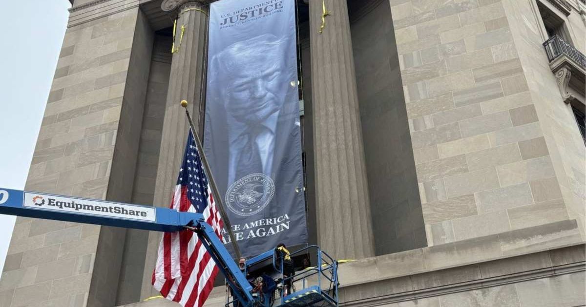 The blue-toned image of President Donald Trump marked a striking addition to the historic Robert F Kennedy Department of Justice Building (X/@EricLDaugh)