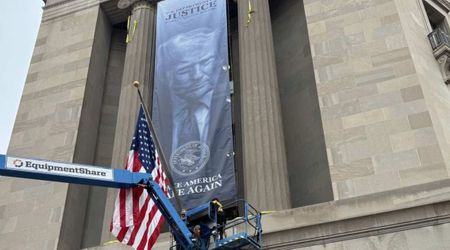 Giant Trump banner hangs outside Justice Department headquarters