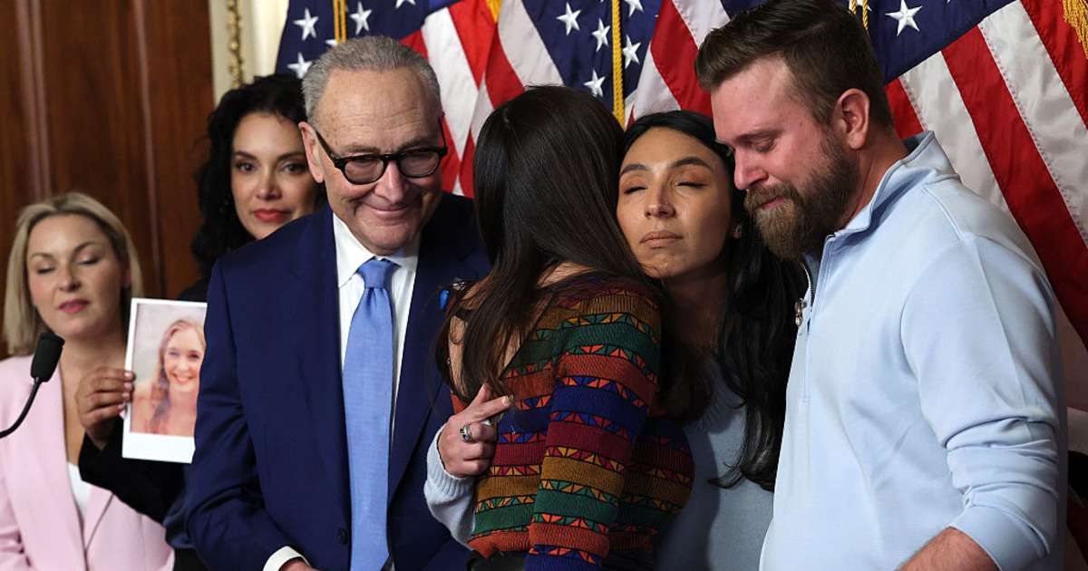 Rep Teresa Leger Fernández hugs Amanda Roberts alongside Sky Roberts, brother of Jeffrey Epstein survivor Virginia Giuffre, as Senate Minority Leader Chuck Schumer looks on  (Getty Images) 