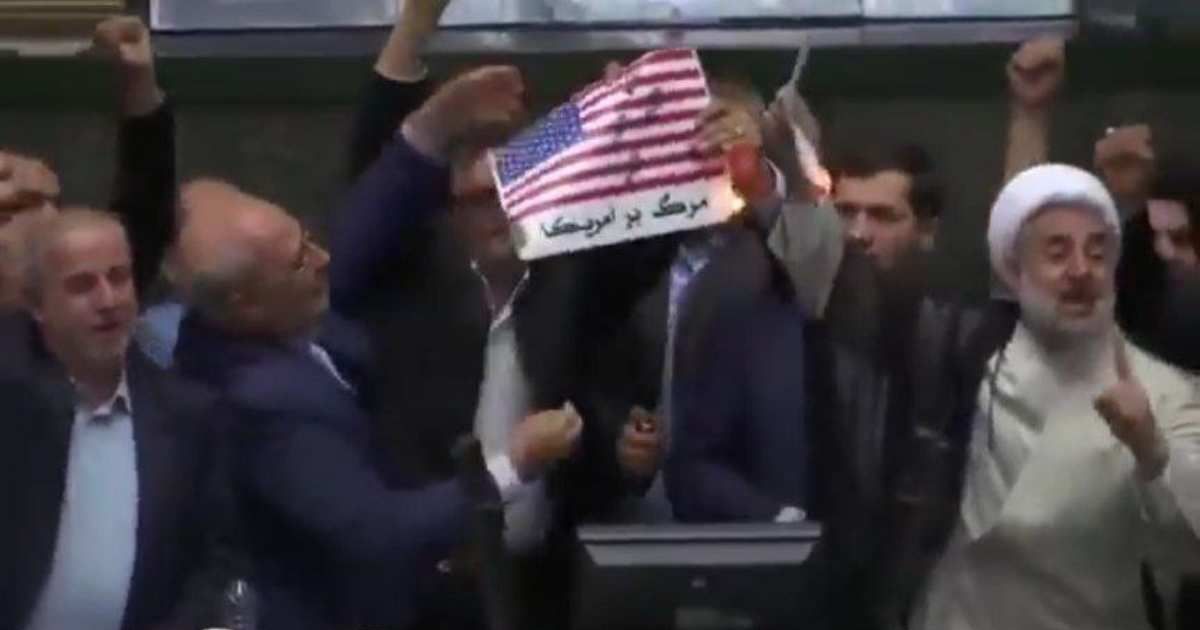 Viral video claims to show Iranian lawmakers burning the US flag in response to missile strikes (@TaraBull/X)