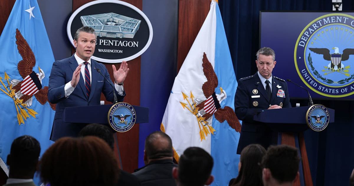 Pete Hegseth speaks as Dan Caine, chairman of the Joint Chiefs of Staff, listens during a news conference at the The Pentagon on March 2, 2026 (Getty Images)
