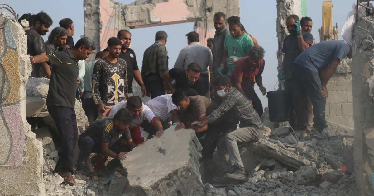 Rescue workers and residents search through the rubble in the aftermath of a strike on a girls' elementary school in Minab, Iran, on February 28, 2026 (Abbas Zakeri/Mehr News Agency via AP)