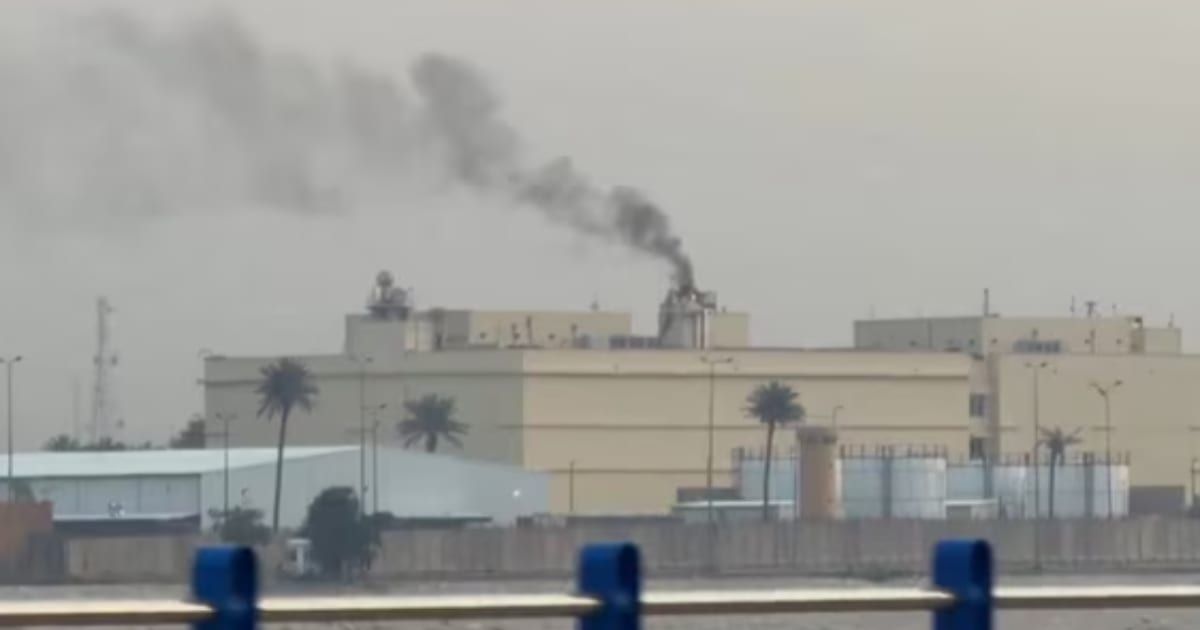 Smoke billowed from the US Embassy in Baghdad after a missile attack hit the compound on Friday (AP/ Youtube)