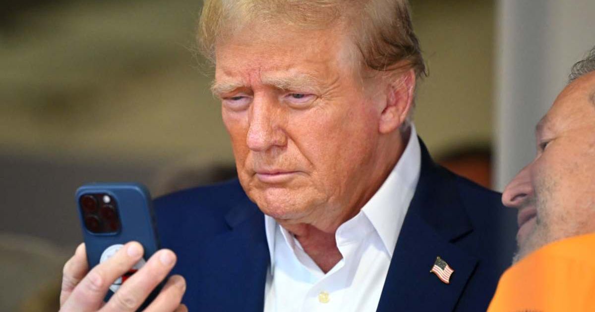 Donald Trump talks on the phone in the McLaren garage prior to the F1 Grand Prix of Miami at Miami International Autodrome on May 05, 2024 in Miami, Florida (Clive Mason/Getty Images)