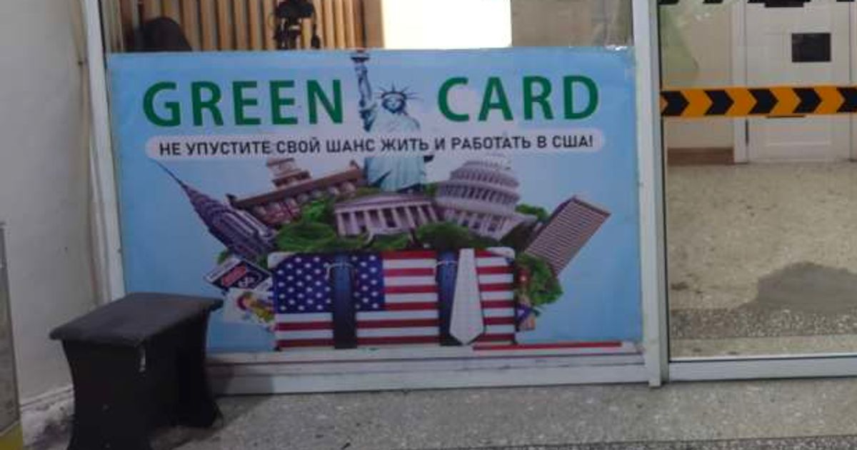 A poster advertising the services of a company that helps obtain a Green Card for work in the United States is displayed in a hardware store in Dushanbe, Tajikistan (Contributor/Getty Images)