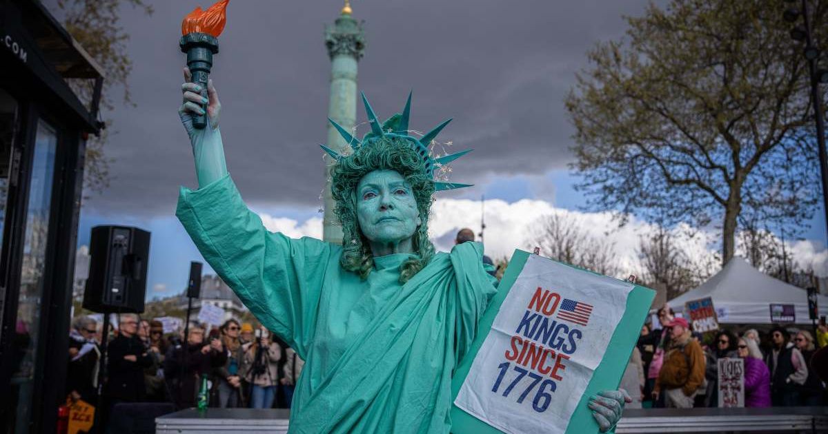 A woman dressed as the Statue of Liberty participates in a 'No Kings' protest in Paris, France, on Saturday, March 28, 2026 (AP Photo/Aurelien Morissard)