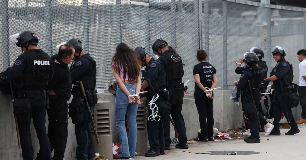 LAPD authorities cleared Alameda Street on Saturday night after a 'No Kings' protest turned into a clash involving tear gas and over 70 arrests (AP Photo/Jill Connelly)