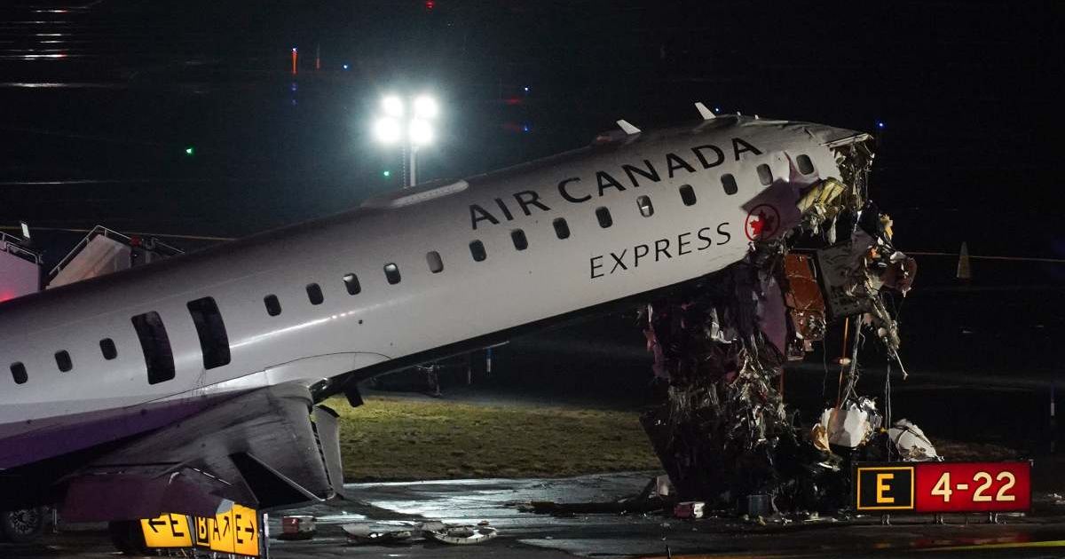 An Air Canada Jet sits on the runway at LaGuardia Airport, Monday, March 23, 2026, after colliding with a Port Authority aircraft rescue and firefighting vehicle after landing in New York (AP Photo/Ryan Murphy)