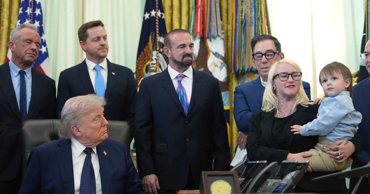 Sierra Smith holds her son, Travis, 2, during an event on healthcare affordability with President Donald Trump in the Oval Office at the White House, Thursday, April 23, 2026, in Washington (AP Photo/Mark Schiefelbein)