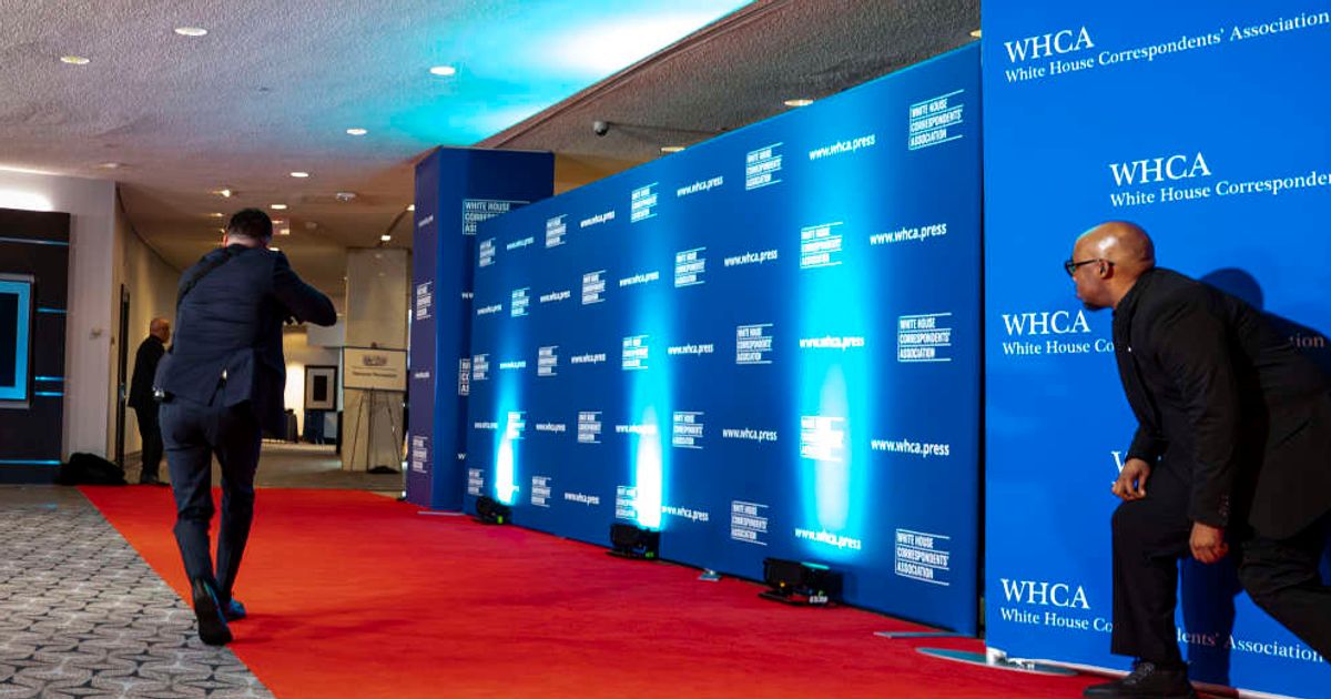 A US Secret Service agent walks past the red carpet with their weapons drawn at the Washington Hilton, venue for the White House Correspondents’ Dinner, on April 25, 2026, in Washington, DC (Al Drago/Getty Images)